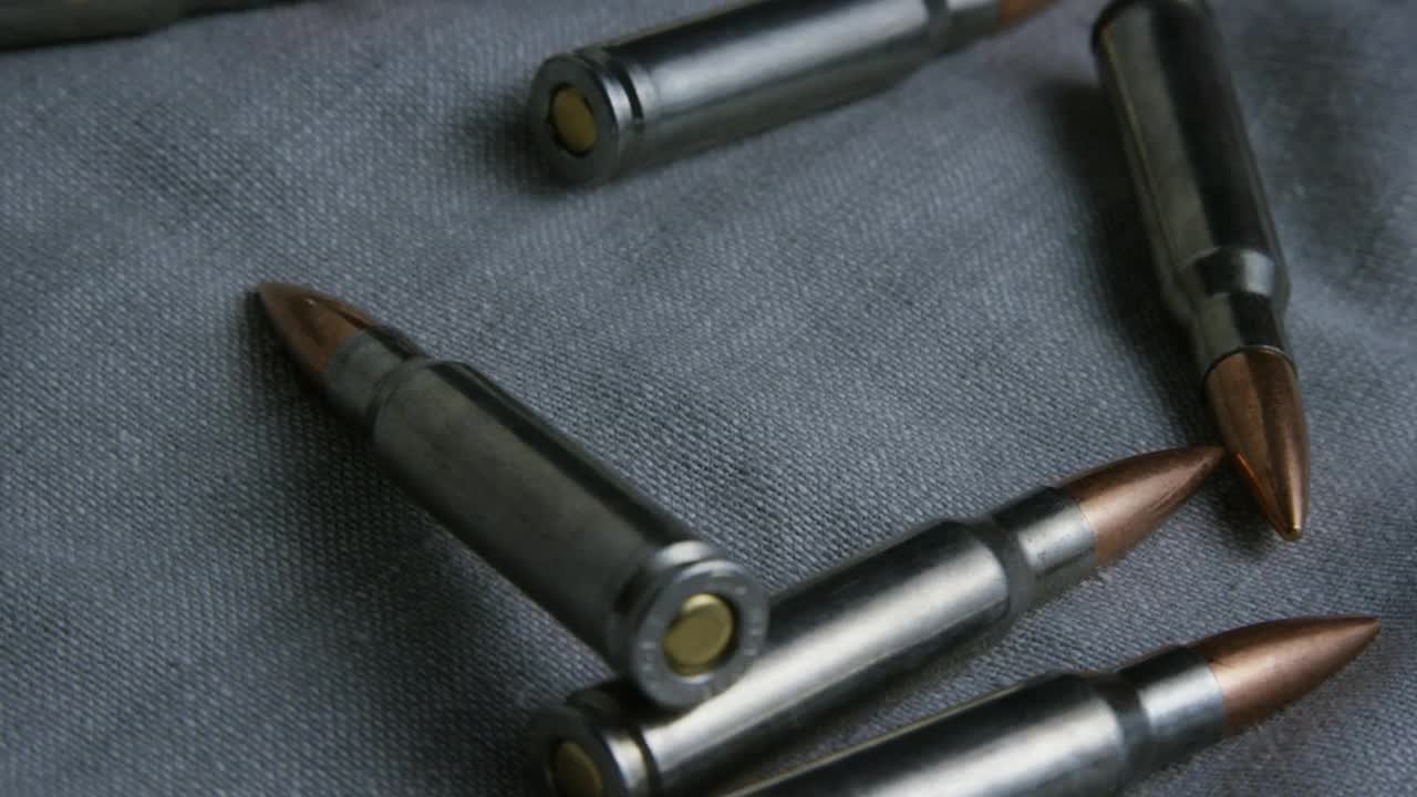 Stock Video Big Bullets Over A Fabric Live Wallpaper For PC - Free Download
