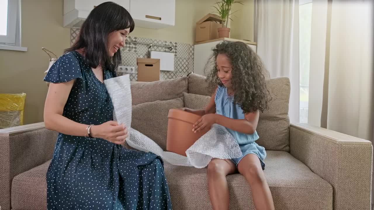 Stock Video Diverse Mom And Daughter Play On Sofa In New Home Live Wallpaper For PC - Free Download