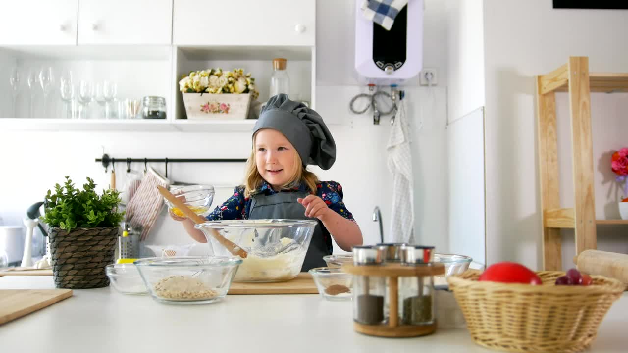 Stock Video Girl In The Kitchen Preparing A Mixture In A Bowl Live Wallpaper For PC - Free Download