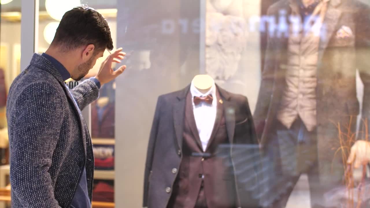 Stock Video Man Looking At The Sideboard Of A Suit Stor Animated Wallpaper - Free Download