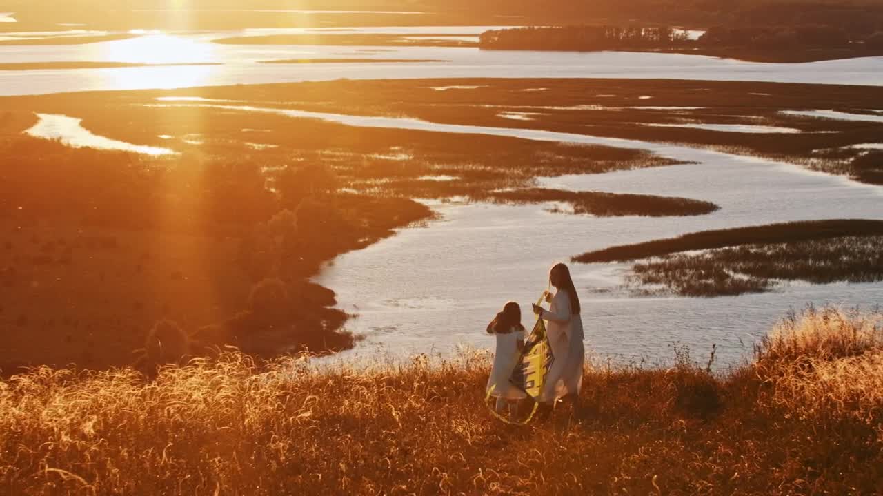 Stock Footage Woman And Her Daughter Walking With A Kite At The Live Wallpaper - Free Download