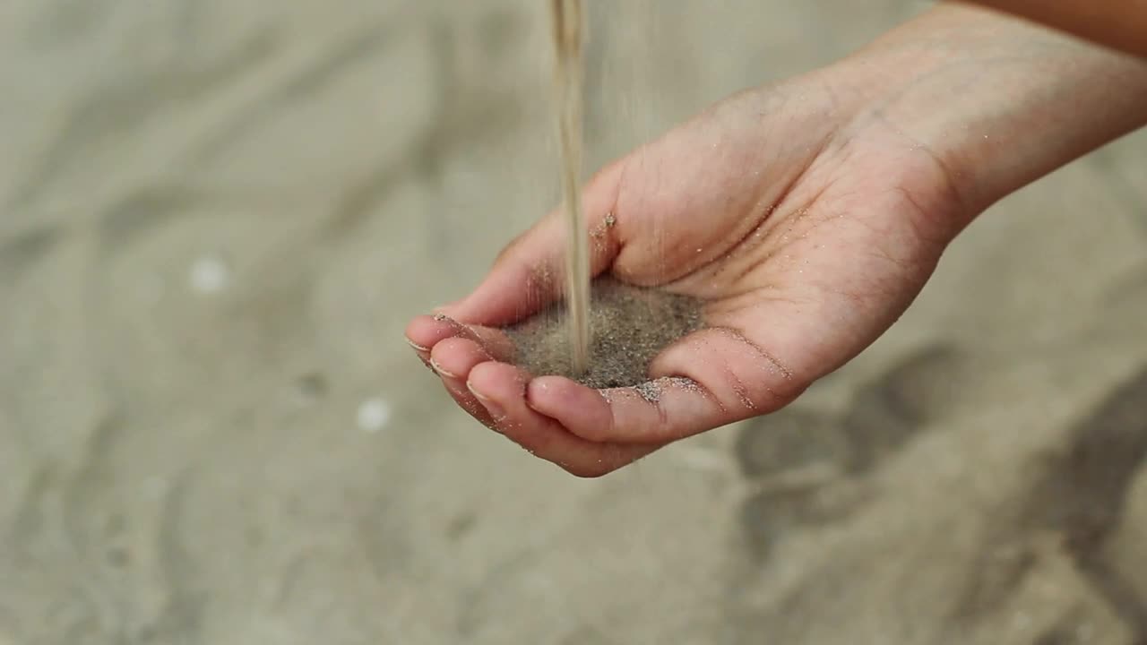 Stock Video Person Passing Sand From One Hand To Another Live Wallpaper - Free Download