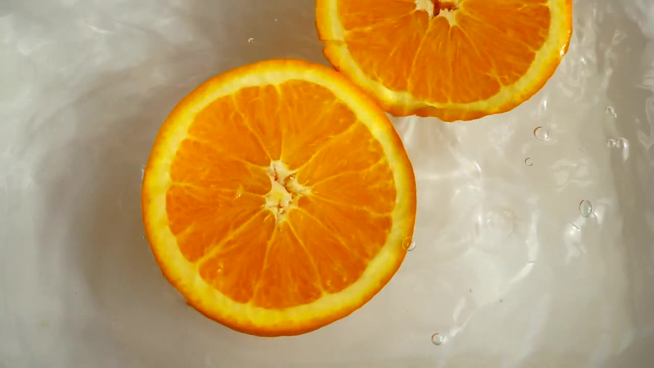 Stock Video Orange Half Spinning While Floating In Water Live Wallpaper - Free Download