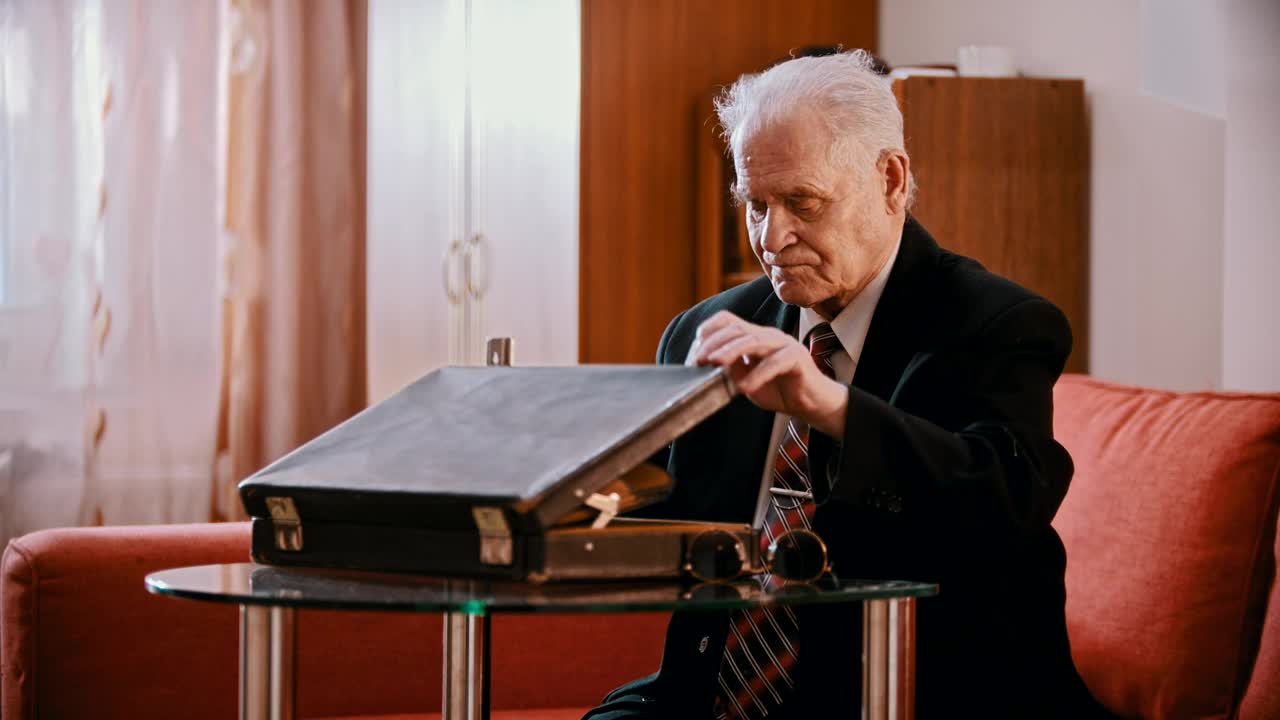 Stock Video Old Gangster Taking A Gun Out Of A Briefcase Live Wallpaper - Free Download
