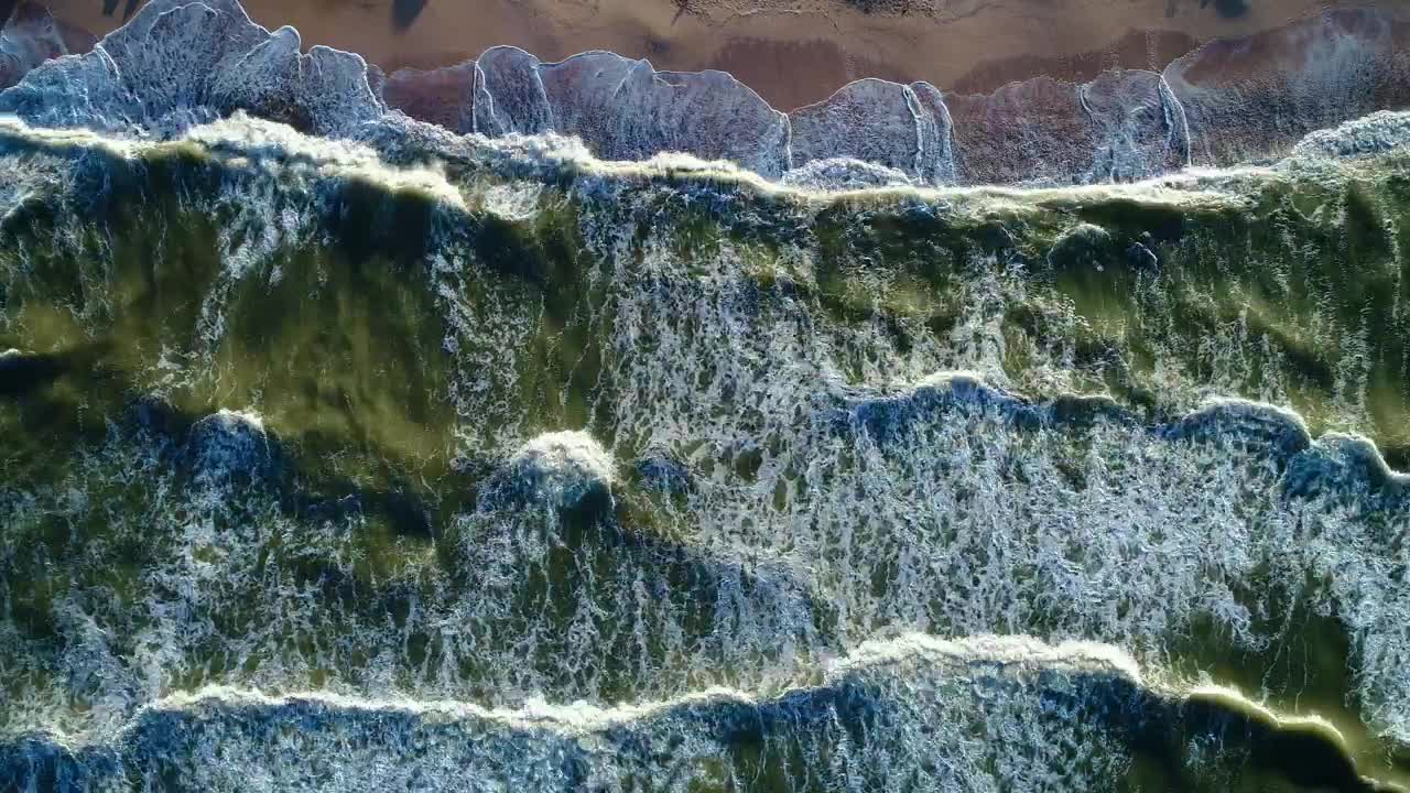Free Video Stock top aerial view of the sea waves reaching a beach Live Wallpaper - Free Download
