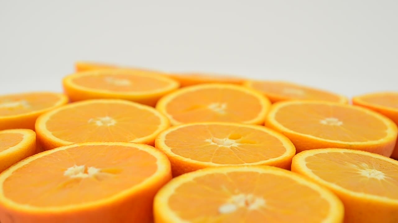 Stock Video Orange Halves Spinning With A White Background Live Wallpaper - Free Download