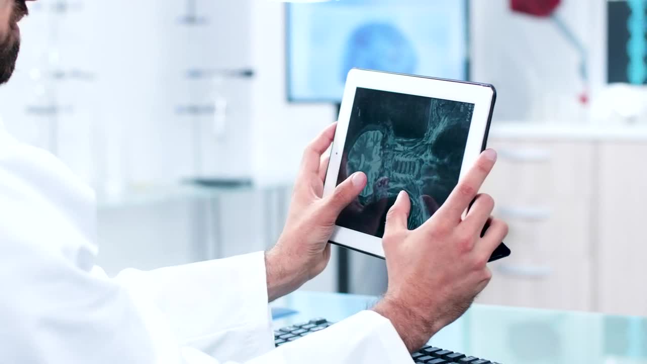 Stock Video Doctor Reviewing A Scan On Their Tablet Live Wallpaper For PC - Free Download