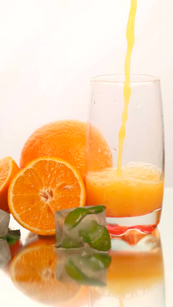 Free Stock Video Serving Juice In A Glass With Some Oranges On A Live Wallpaper - Free Download