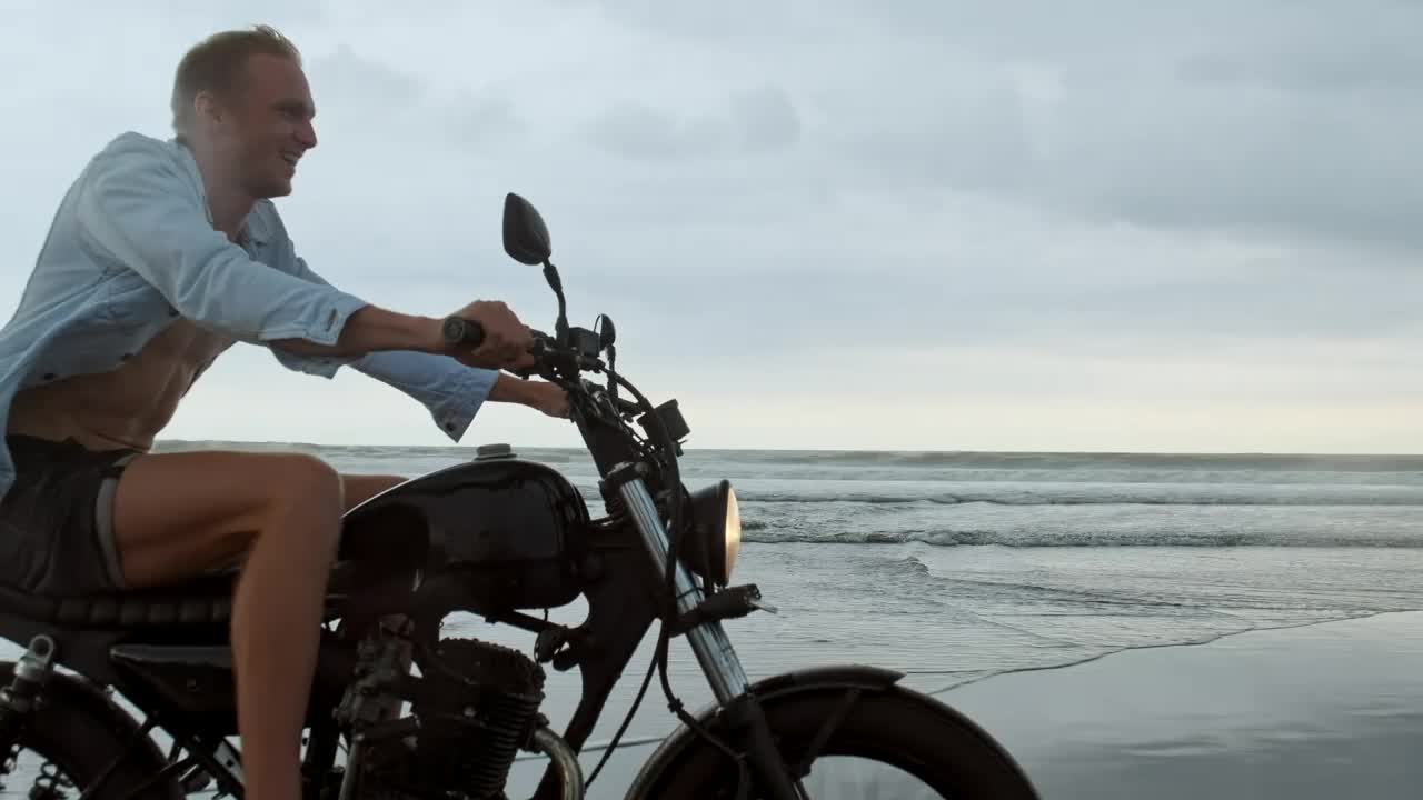 Stock Video Happy Wanderlust Riding A Motorcycle At The Beach Animated Wallpaper - Free Download