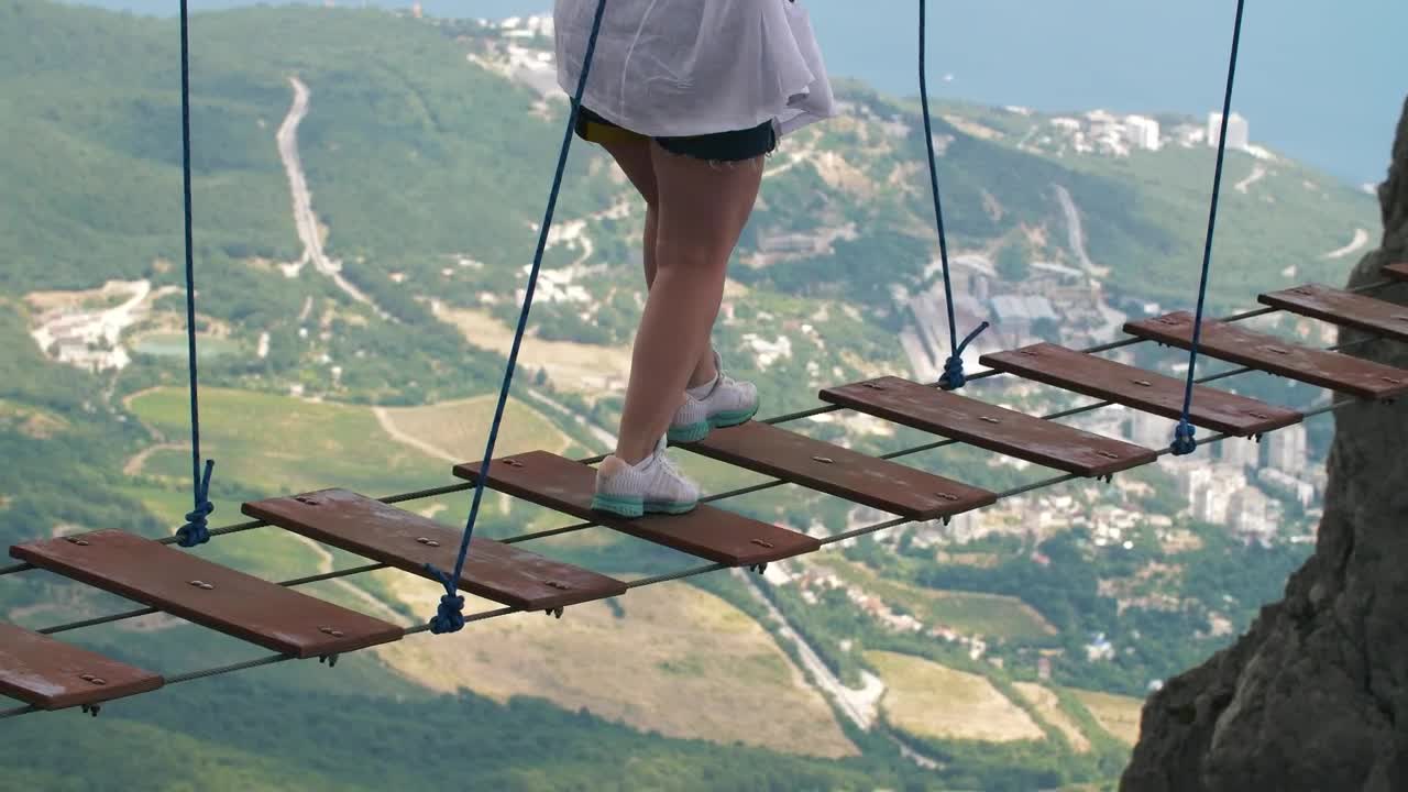 Stock Video Person On A Suspension Bridge Between Mountains Live Wallpaper - Free Download