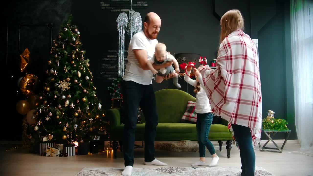 Stock Video Happy Parents Play With Their Daughters At Christmas Animated Wallpaper - Free Download