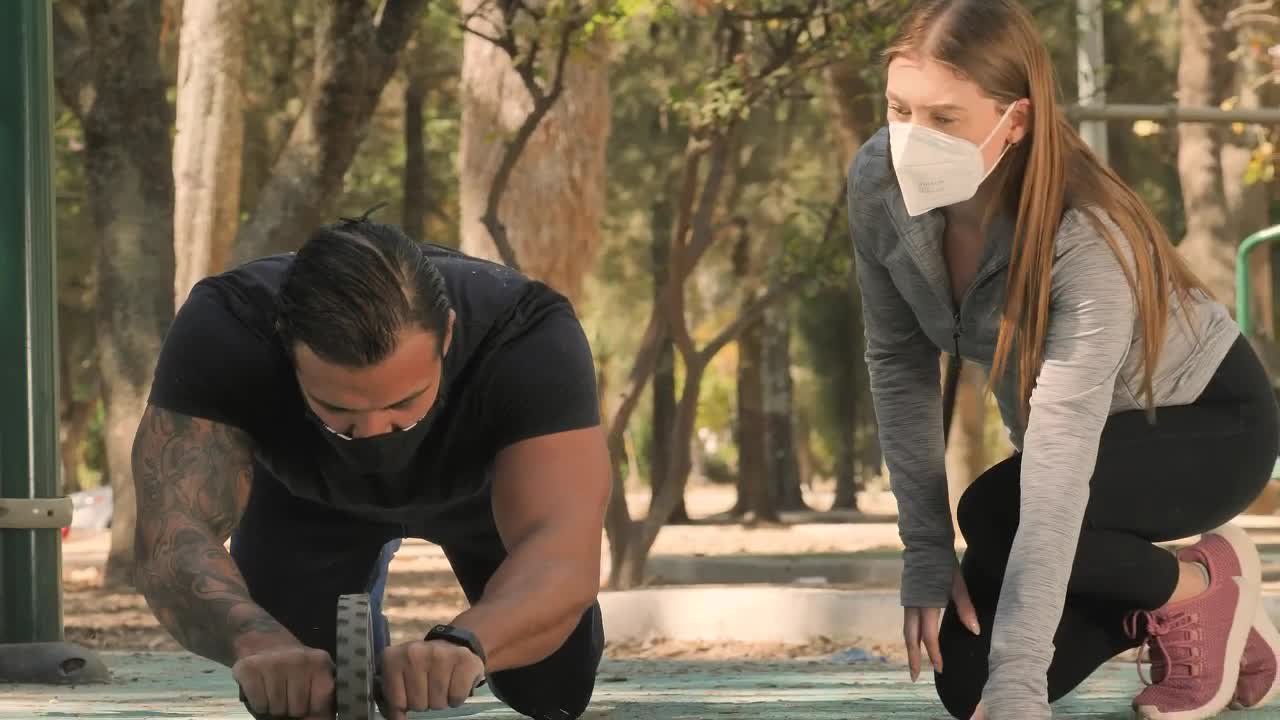 Stock Video Healthy Couple Doing Exercises At A Park Animated Wallpaper - Free Download