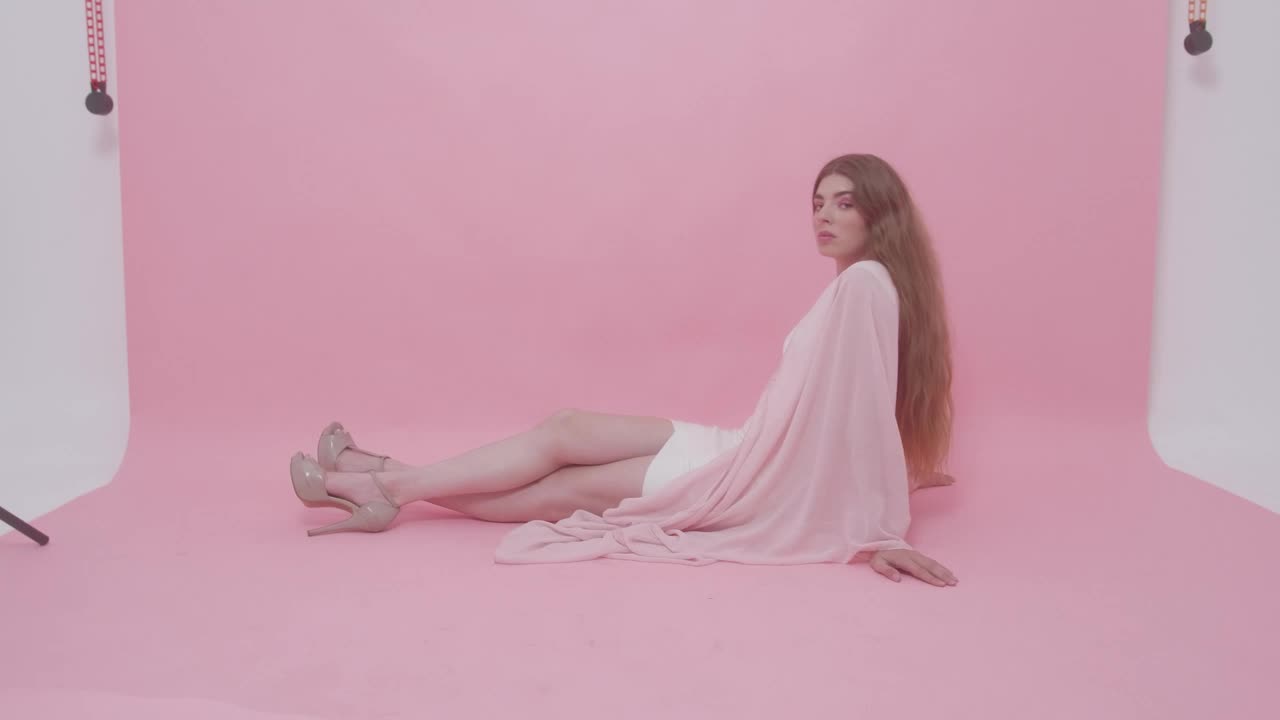 Stock Video Model Posing On The Floor Of A Photographic Se Animated Wallpaper - Free Download