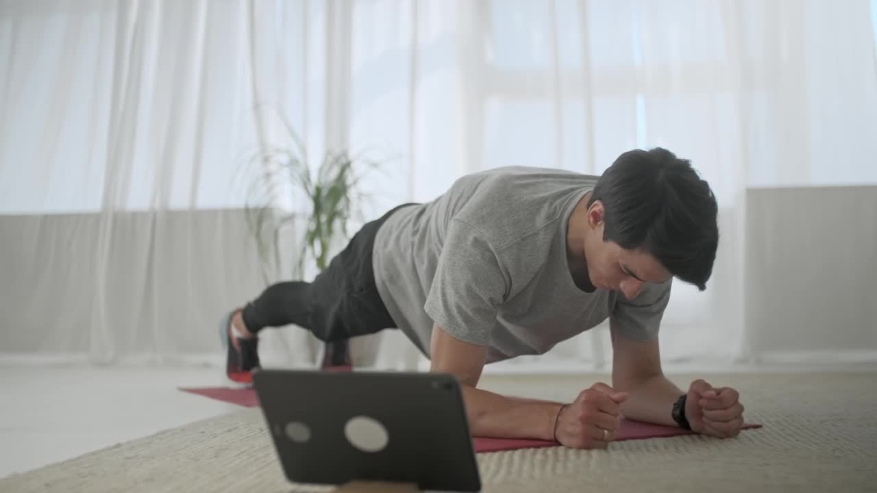 Stock Video Man Doing Plank Exercise In His Living Room Animated Wallpaper - Free Download