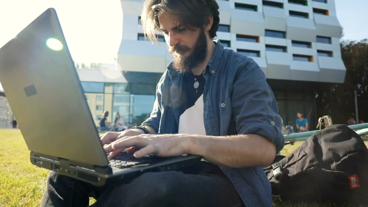 Stock Video Man Typing On Laptop Outside Smiles In Triump Animated Wallpaper - Free Download