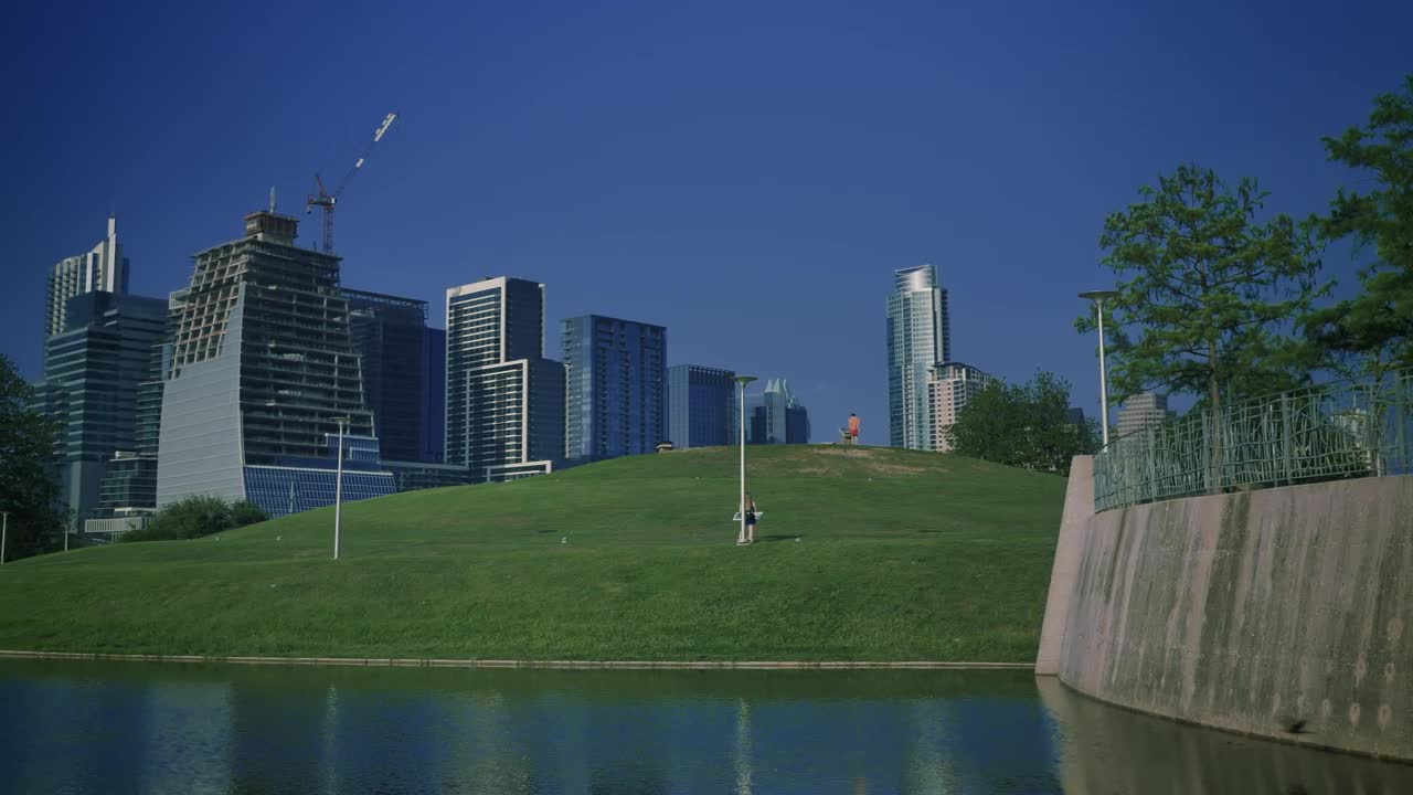 Free Video Stock tall buildings surrounding a natural park in a city Live Wallpaper - Free Download