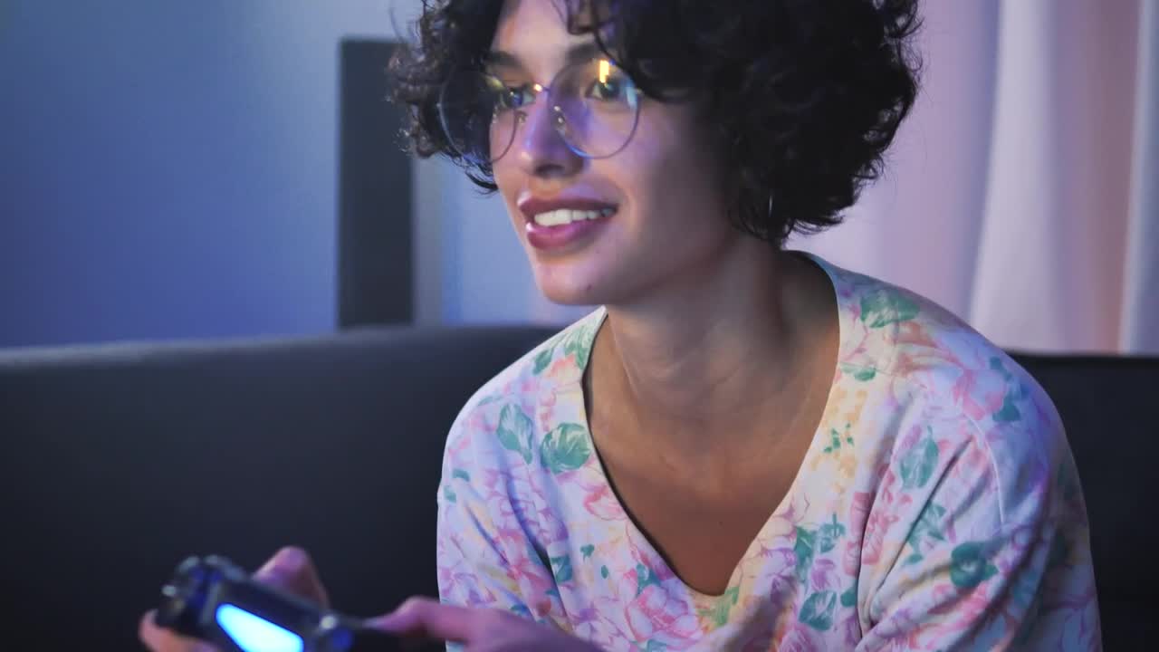 Free Video Stock teen with glasses playing video games on the sofa Live Wallpaper - Free Download
