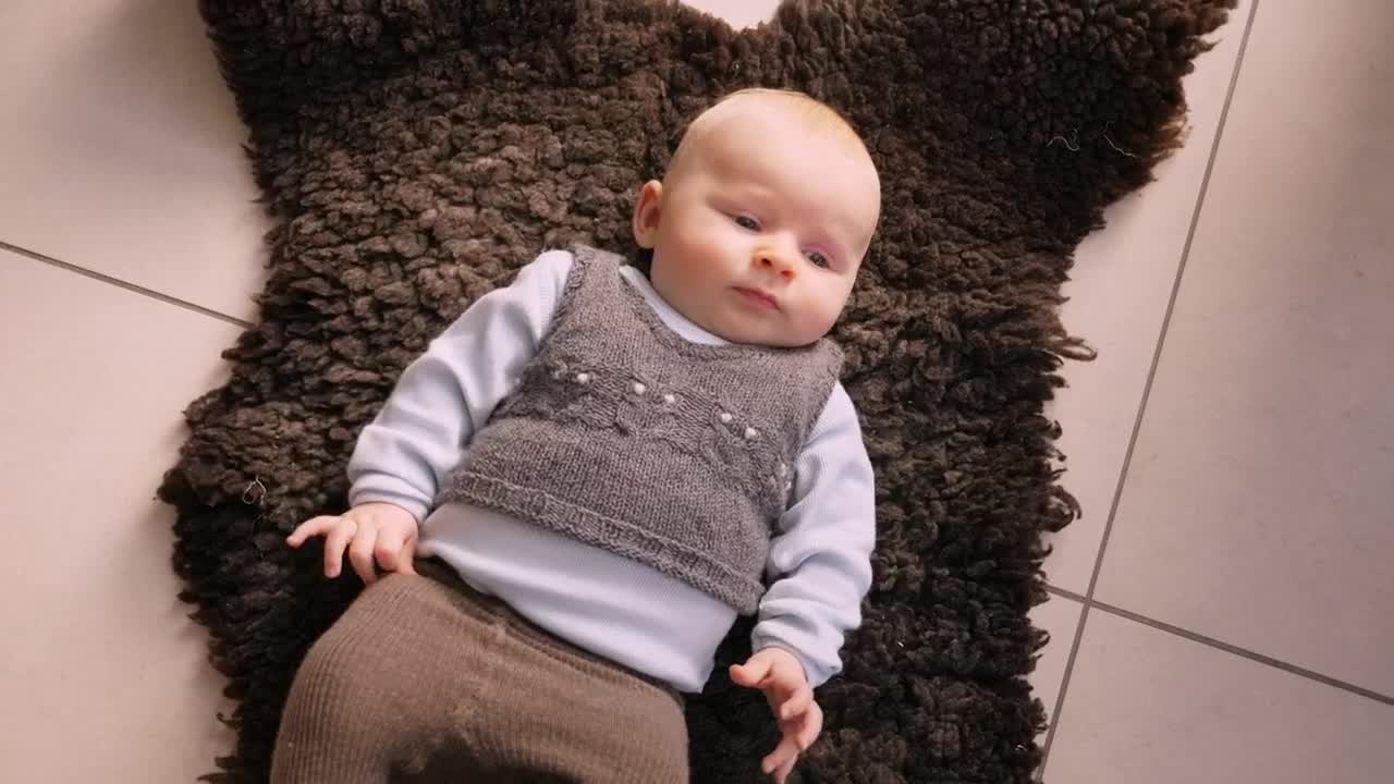 Stock Video Infant Laying On A Rug Animated Wallpaper - Free Download