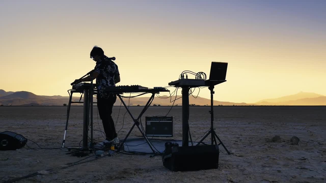 Stock Video Dj Mixing Music In The Middle Of A Vast Desert Live Wallpaper For PC - Free Download