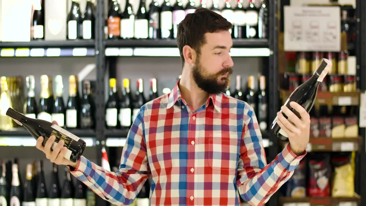 Stock Video Man Confused Over Which Wine To Buy Animated Wallpaper - Free Download