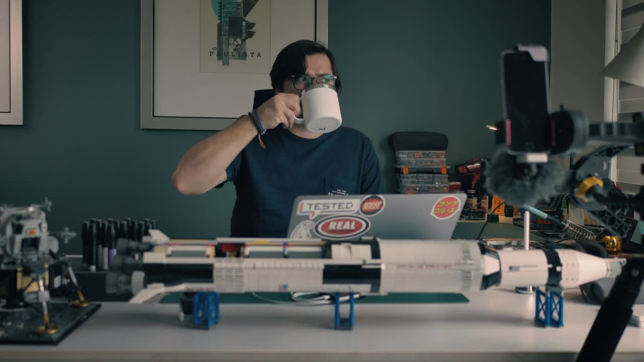 Stock Video Man At His Laptop In His Study With Many Objects Animated Wallpaper - Free Download