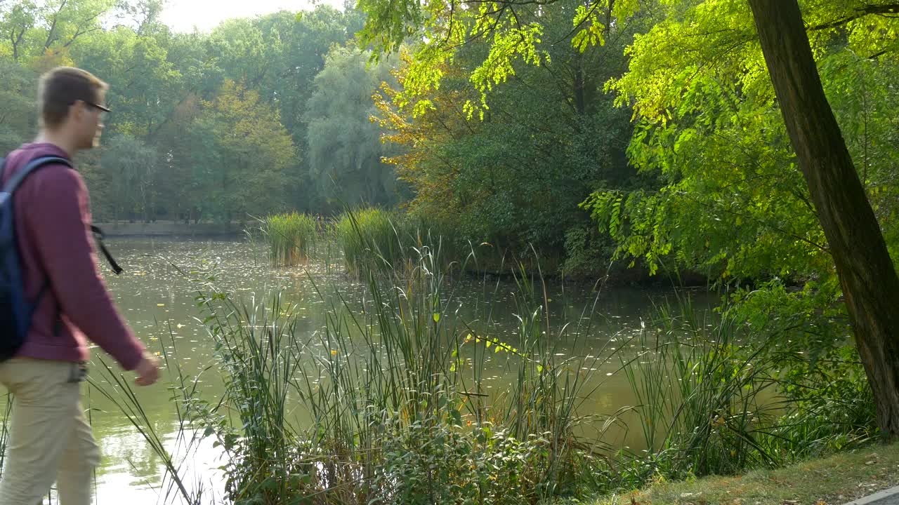 Stock Video Man Walking By The Riverside Takes A Brea Animated Wallpaper - Free Download