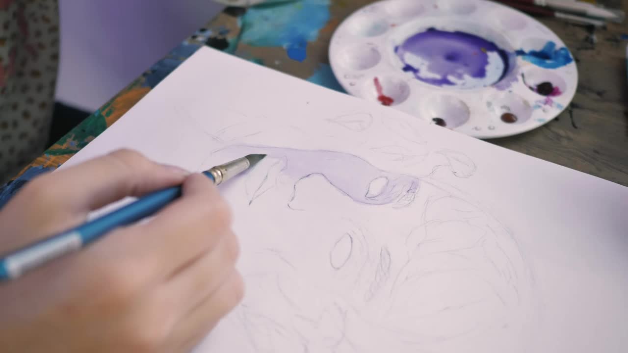 Stock Video Hand Of An Artist Painting A Face With Watercolors Live Wallpaper For PC - Free Download