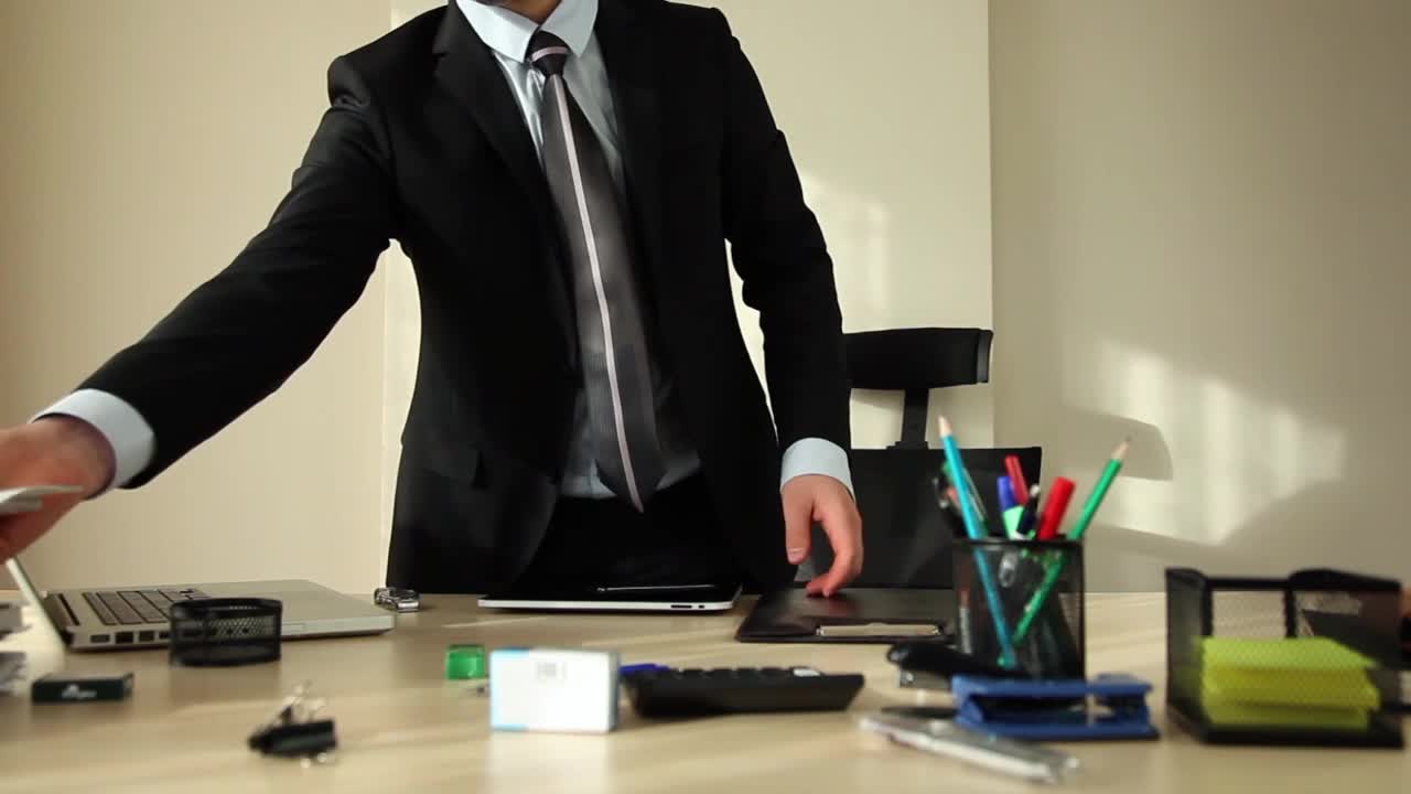 Stock Video Man In A Suit Organizing His Office Animated Wallpaper - Free Download