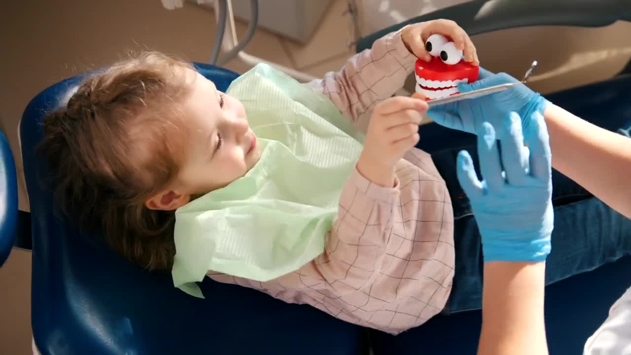Stock Video Dentist Playing With A Little Patient With A Toy Live Wallpaper For PC - Free Download