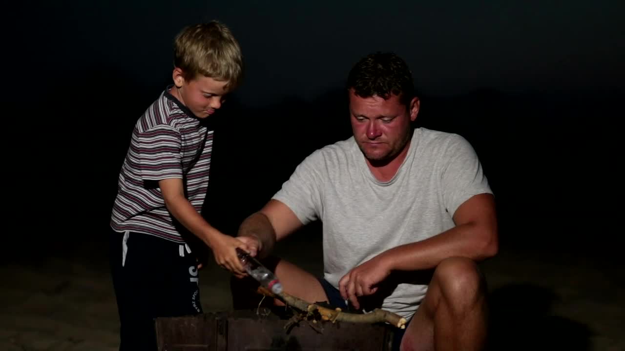 Stock Video Father And Son Lighting A Campfire At Night Live Wallpaper For PC - Free Download