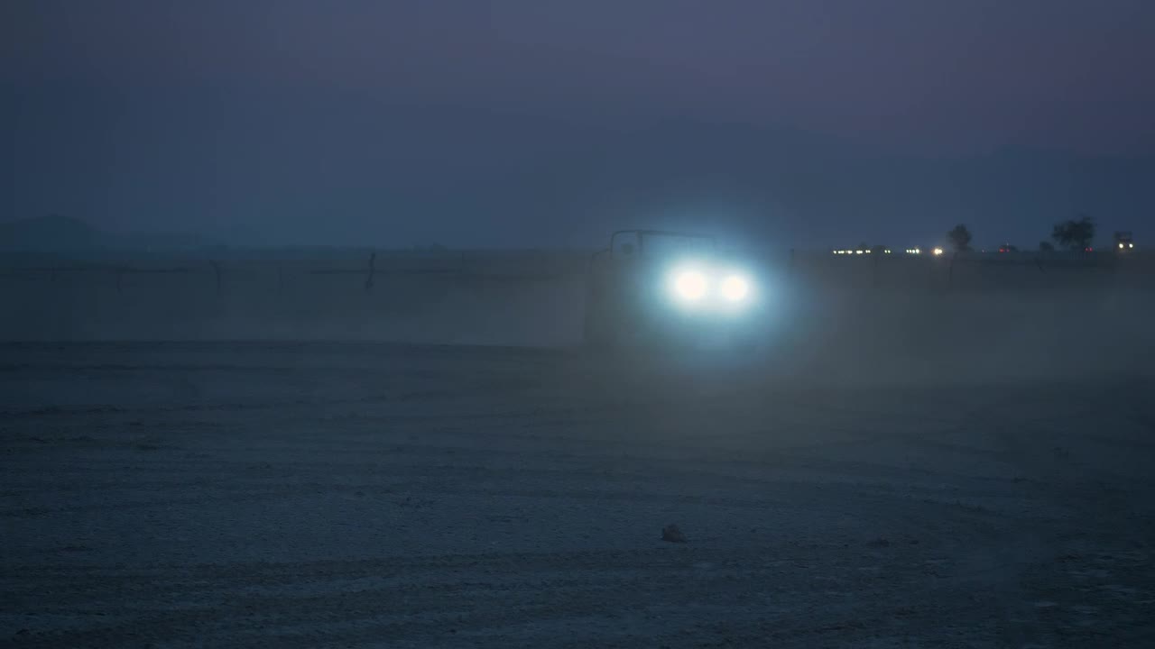 Stock Video Jeep With Headlights On In A Desert At Night Animated Wallpaper - Free Download