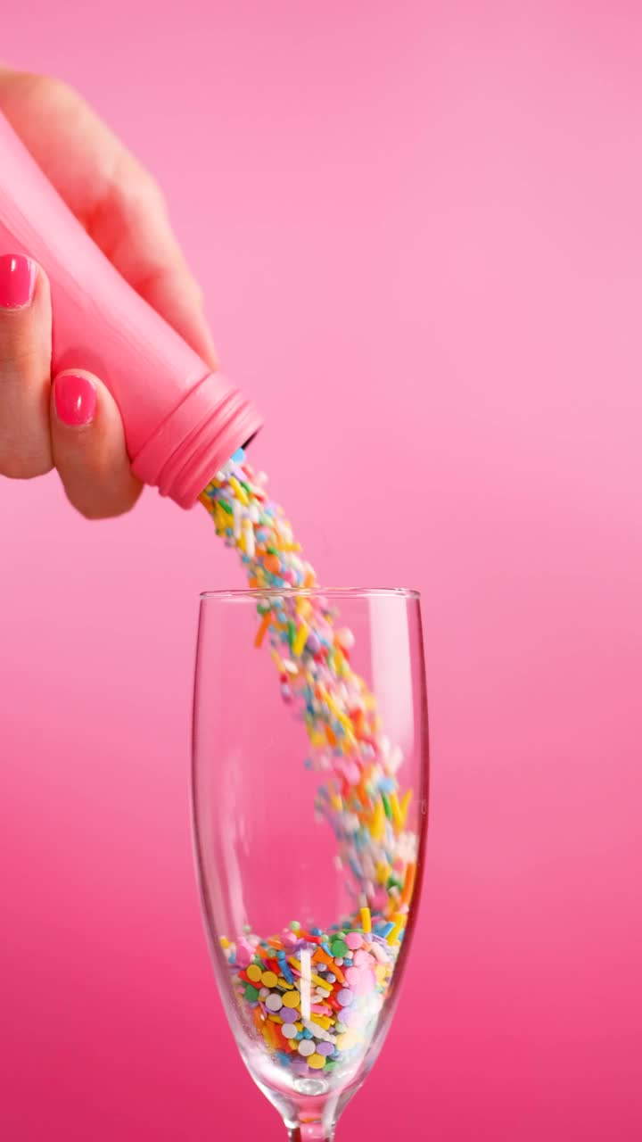 Stock Video Filling A Glass Cup With Small Sweets On A Pink Live Wallpaper For PC - Free Download