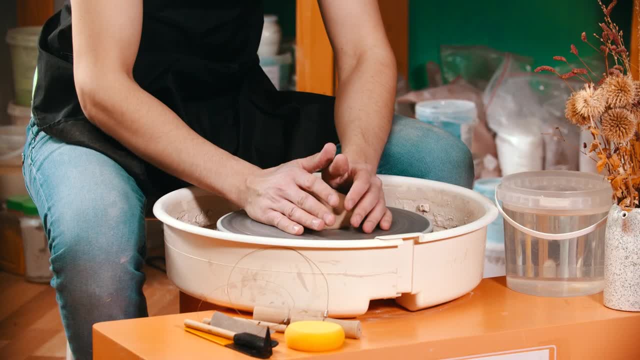 Stock Video Man Molding Clay On The Spinning Whee Animated Wallpaper - Free Download