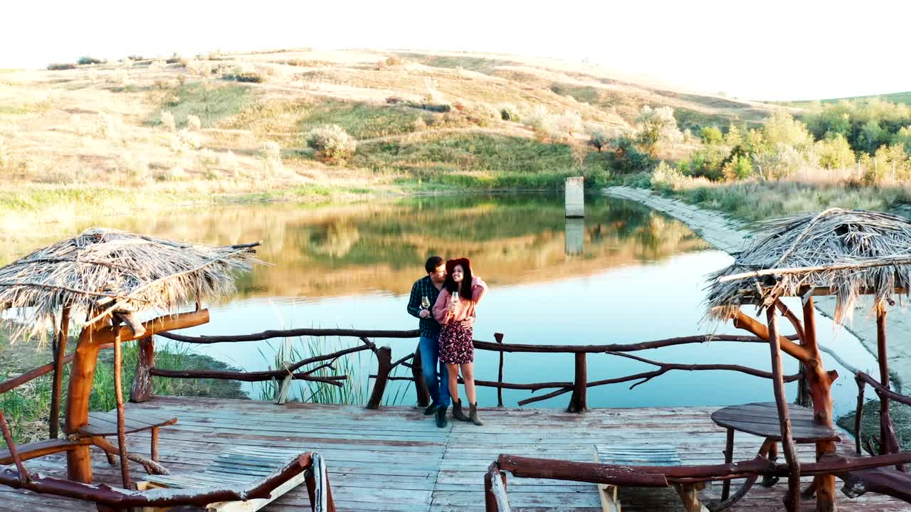 Stock Video Couple Sharing A Drink On A Pier Live Wallpaper For PC - Free Download