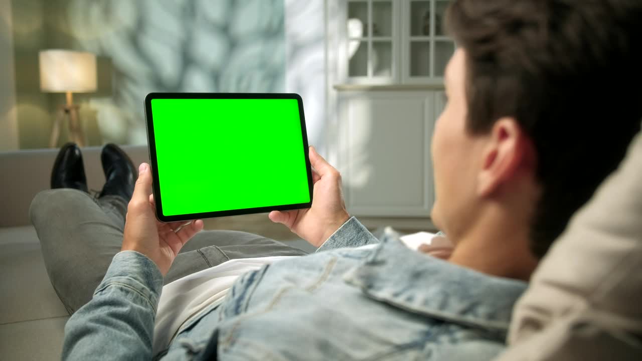 Stock Video Man Relaxing With Green Screen Tablet In Neutral Roo Animated Wallpaper - Free Download