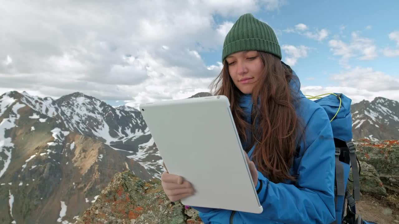 Stock Video Mountaineer Girl Using A Tablet In The Mountains Live Wallpaper - Free Download