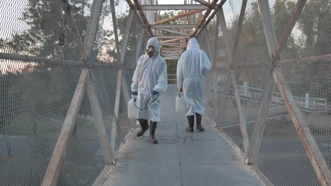 Stock Video People With Masks Sanitizing A Pedestrian Bridge Live Wallpaper - Free Download