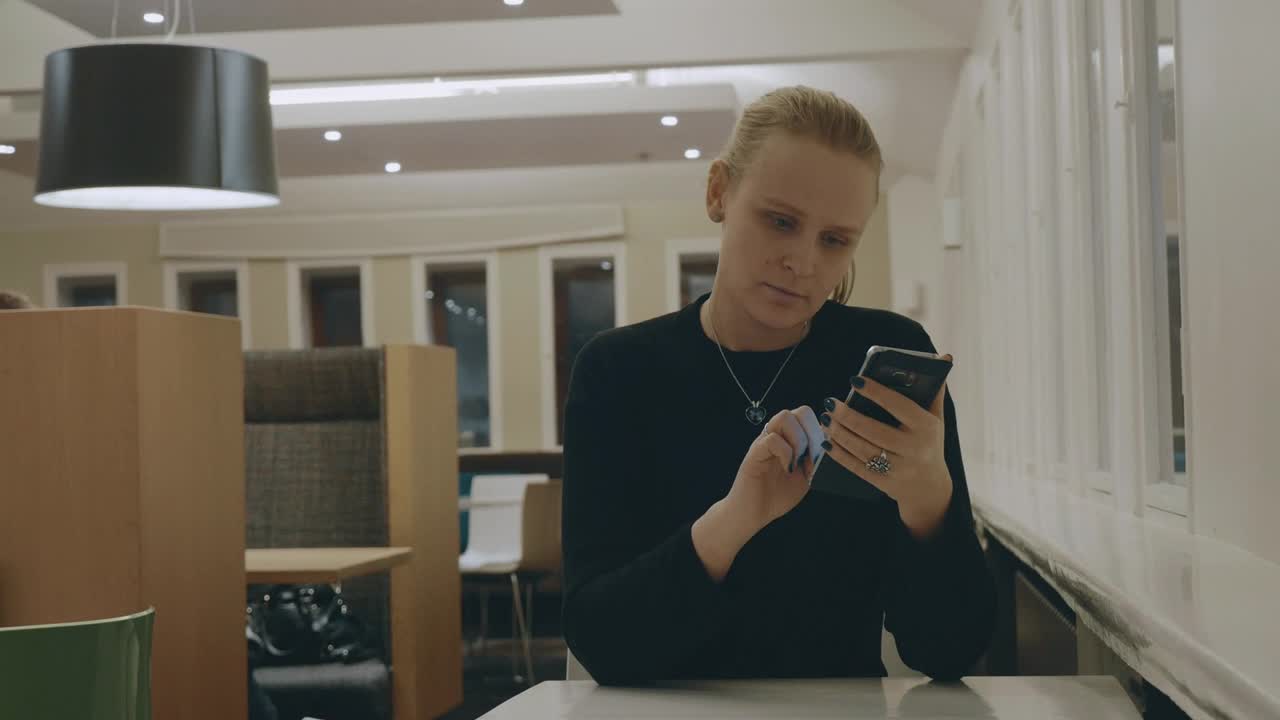 Stock Footage Woman Browsing Her Phone In A Hotel Live Wallpaper - Free Download