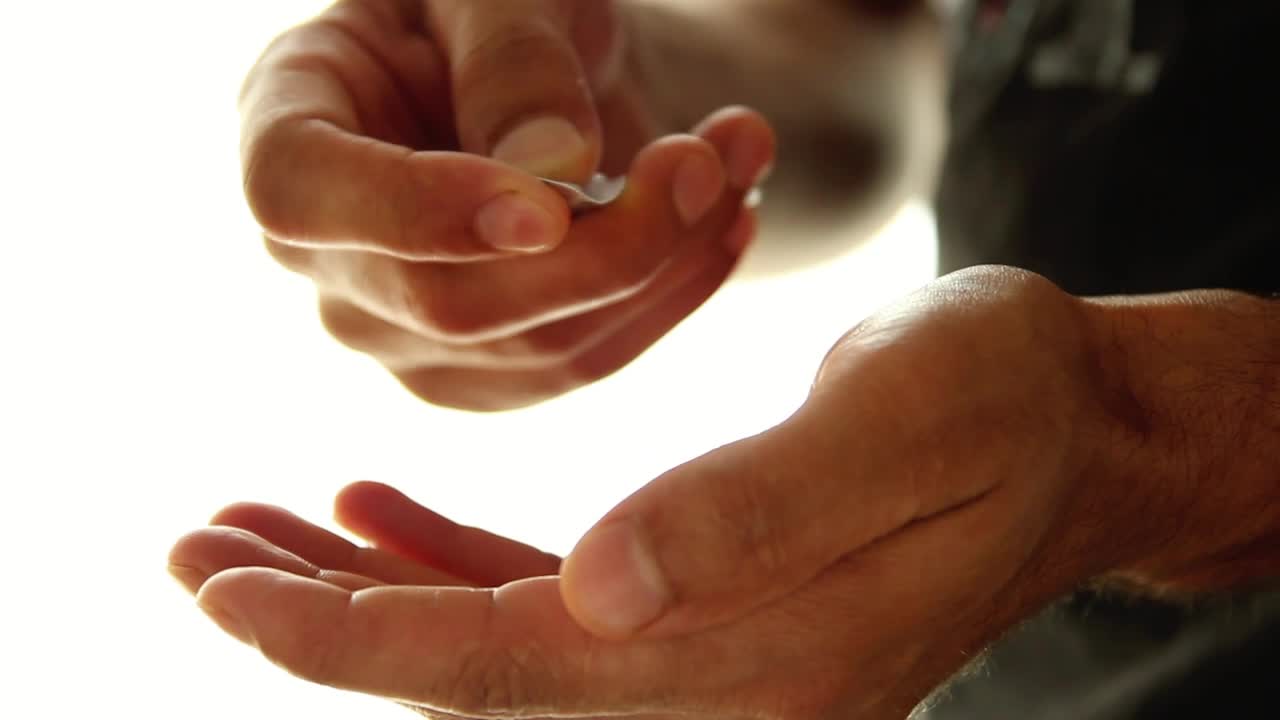 Stock Video Hands Of A Man Taking Pills From A Packaging Animated Wallpaper - Free Download