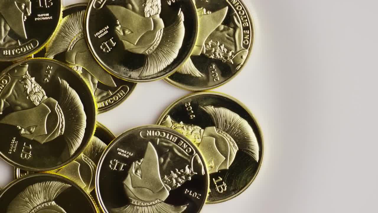 Free Video Stock titan bitcoin gold coins on a white background Live Wallpaper - Free Download