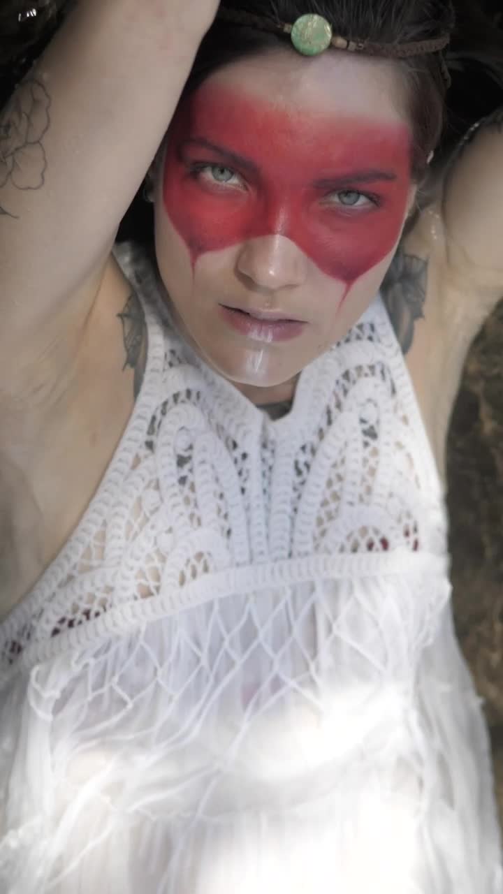 Stock Video Indie Fashion Girl Laying Down On A River Animated Wallpaper - Free Download