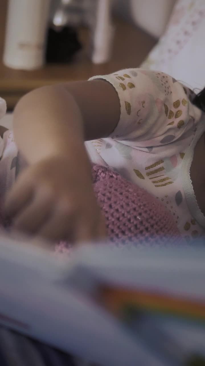Stock Video Little Girl Lying Next To Mom Watching A Storybook With Animated Wallpaper - Free Download