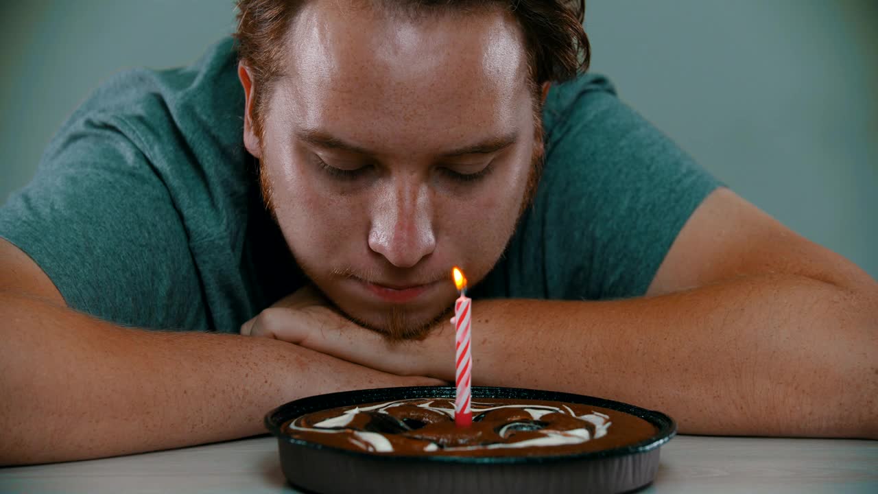Stock Video Crestfallen Man Blowing Out The Candle On A Cake Live Wallpaper For PC - Free Download
