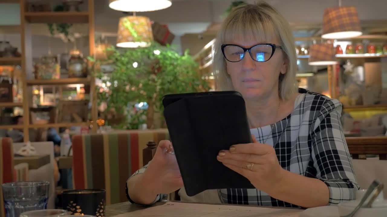 Stock Footage Woman Browsing A Tablet Before Ordering Live Wallpaper - Free Download