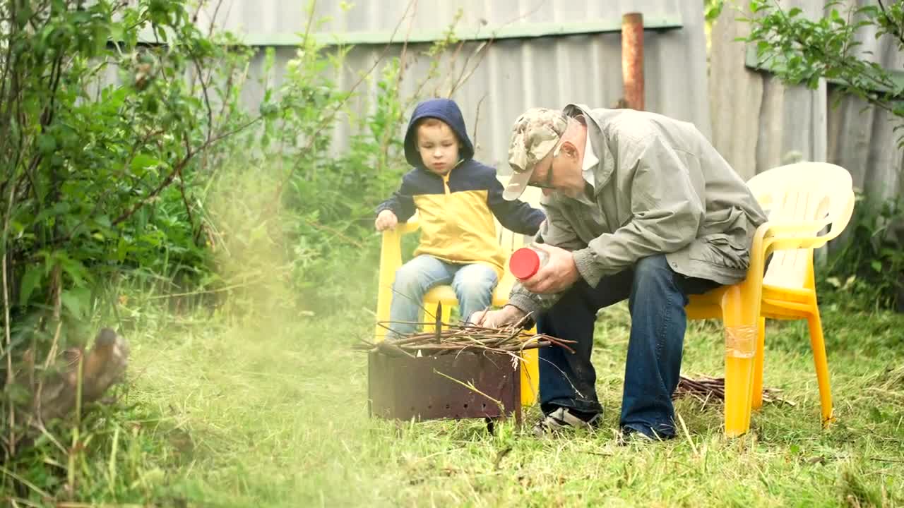 Stock Video Grandfather Preparing A Campfire Live Wallpaper For PC - Free Download