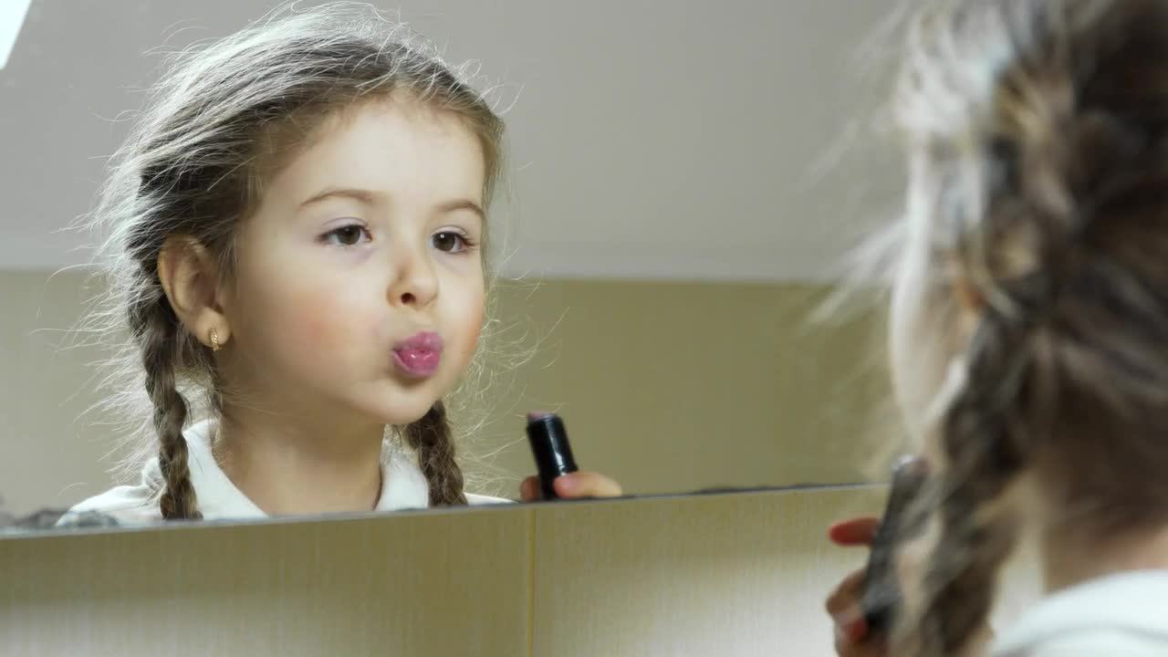Stock Video Little Girl Puts On Lipstick In The Mirror Animated Wallpaper - Free Download