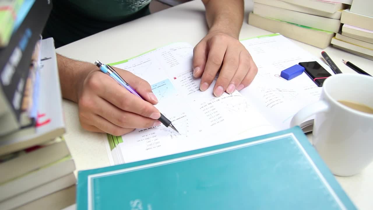 Free Video Stock Student Doing Homework On A Desk With Many Books Live Wallpaper - Free Download