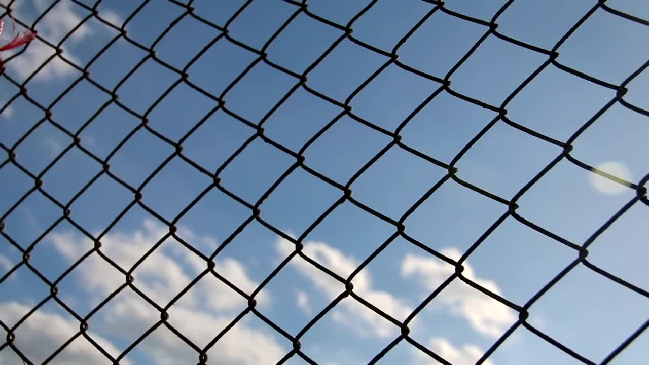 Stock Video Metal Mesh With Blue Sky In The Backgroun Animated Wallpaper - Free Download