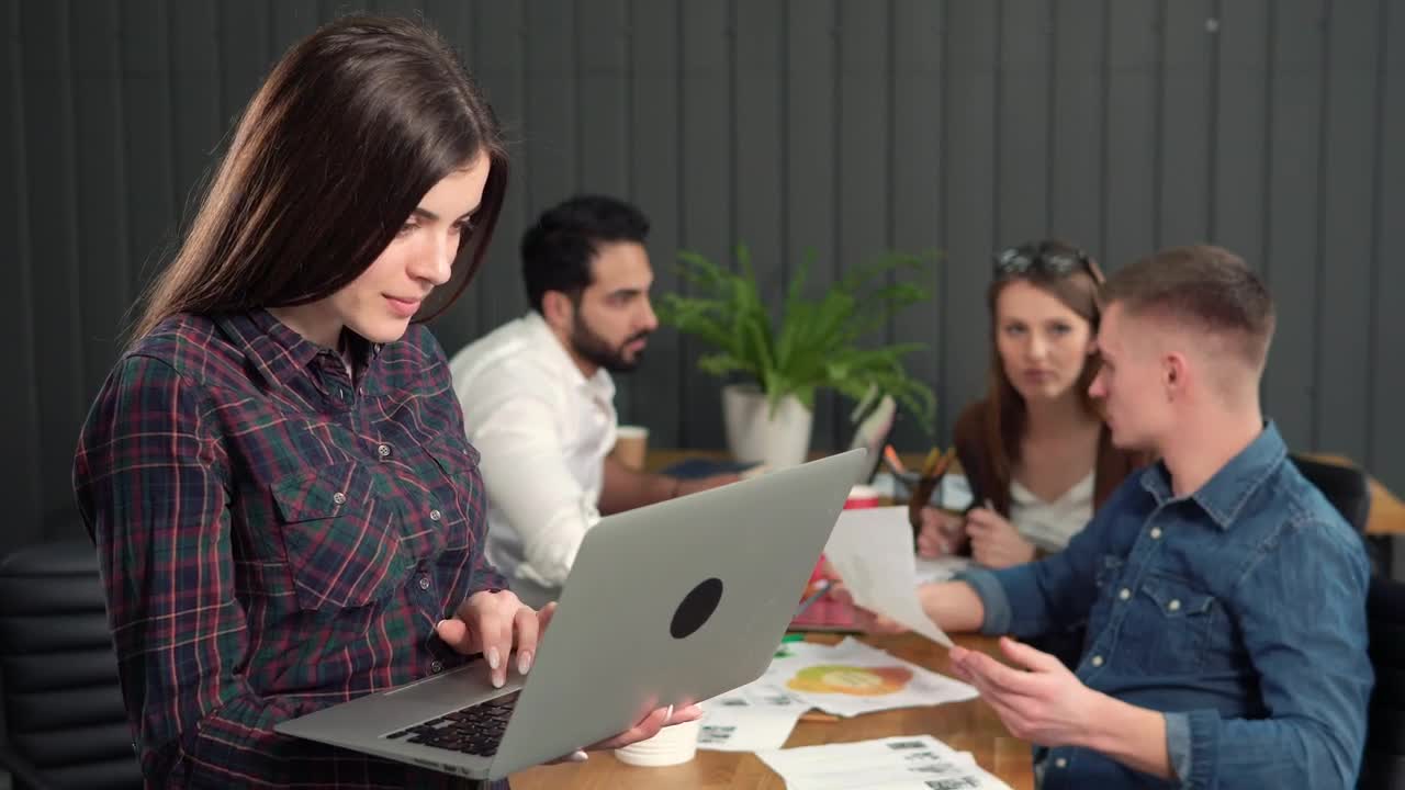 Stock Video Female Team Leader Holding Laptop Turns And Smiles Live Wallpaper For PC - Free Download