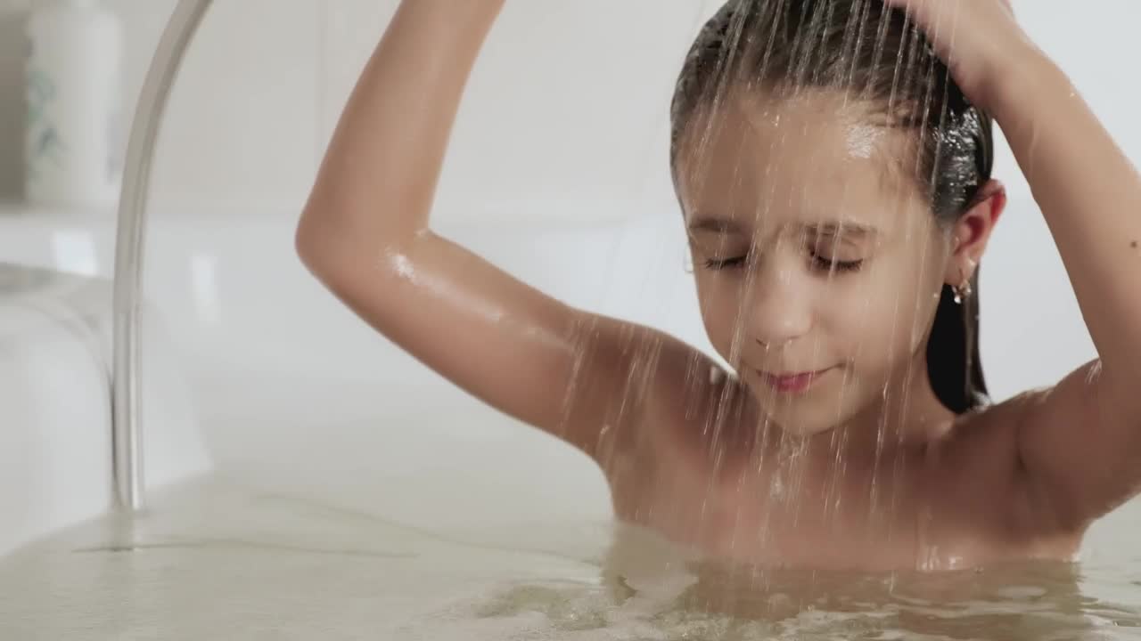 Stock Video Little Girl Rinsing Out The Shampoo From Her Hair In Animated Wallpaper - Free Download